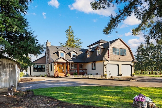 view of front of home with a front yard and a garage