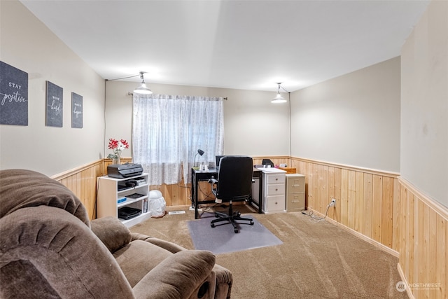 office space featuring light colored carpet and wooden walls