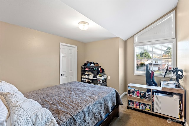 bedroom with lofted ceiling and carpet floors