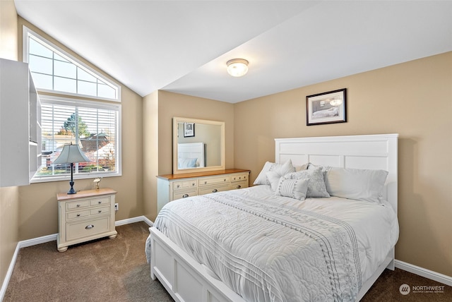 bedroom featuring vaulted ceiling and dark carpet