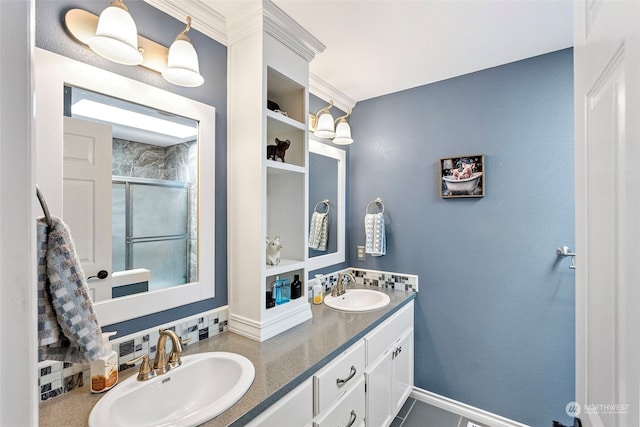 bathroom featuring a shower with shower door, vanity, tile patterned flooring, and crown molding