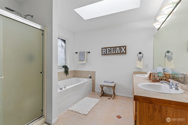 bathroom with vanity, a skylight, tile patterned floors, and independent shower and bath