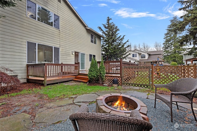 view of patio with a wooden deck and a fire pit