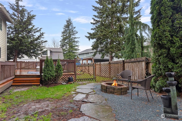 view of patio / terrace featuring a wooden deck and an outdoor fire pit