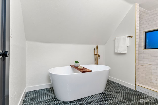 bathroom with independent shower and bath, lofted ceiling, and tile patterned floors