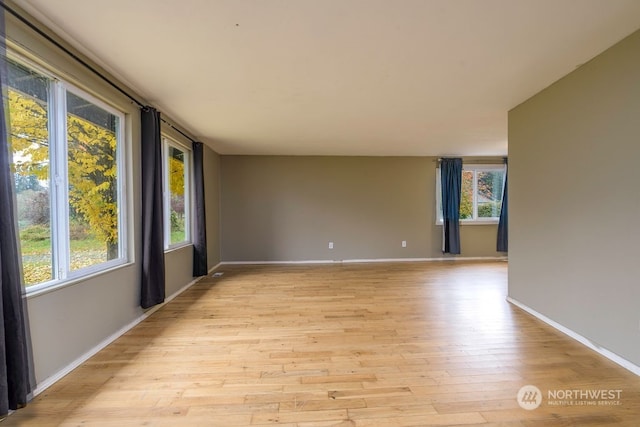 spare room featuring light hardwood / wood-style flooring