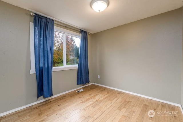 unfurnished room featuring wood-type flooring