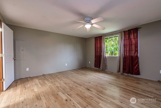 empty room featuring ceiling fan and light hardwood / wood-style flooring