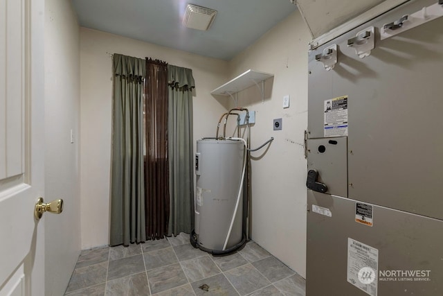 utilities featuring electric water heater and heating unit