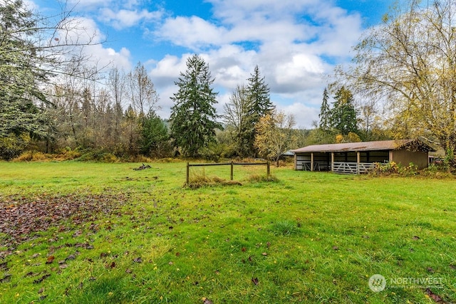 view of yard featuring an outbuilding and a rural view