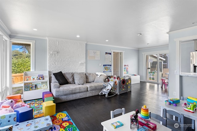 rec room with ornamental molding, dark hardwood / wood-style flooring, and a healthy amount of sunlight