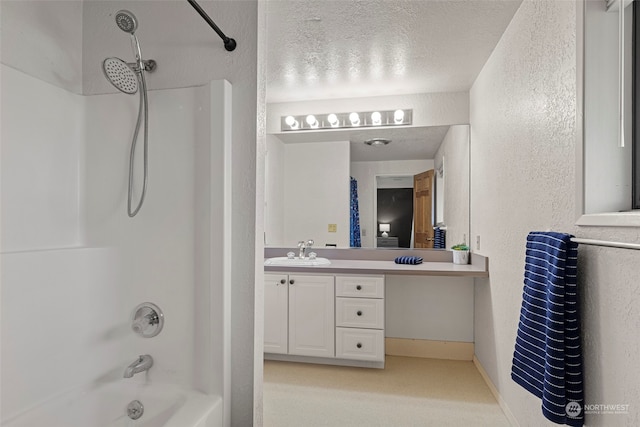 bathroom featuring shower / tub combination, vanity, and a textured ceiling