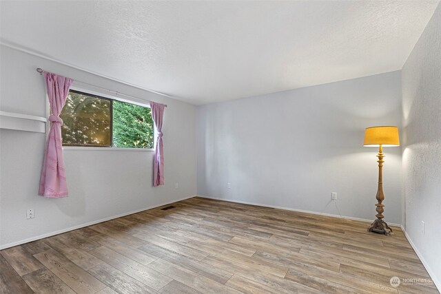 spare room featuring light hardwood / wood-style flooring