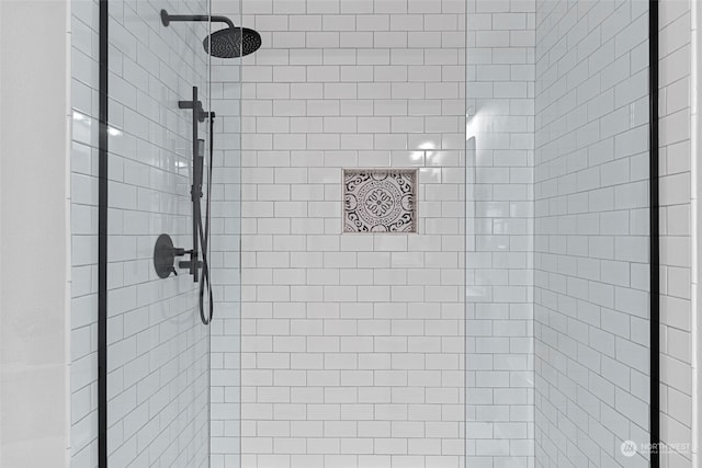 bathroom with tiled shower