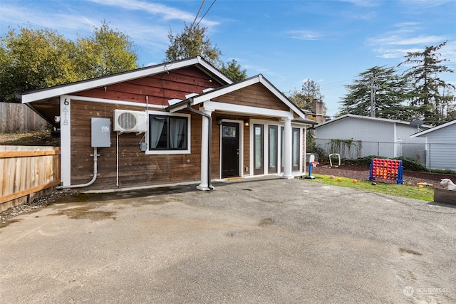 view of front of house with ac unit and a patio