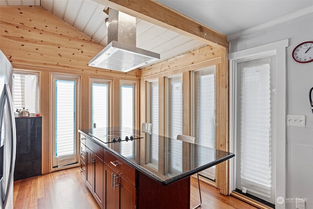 kitchen featuring light hardwood / wood-style flooring, black electric stovetop, lofted ceiling, a center island, and island exhaust hood