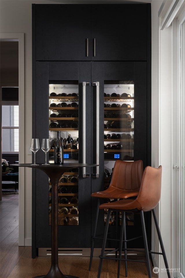 bar with dark wood-type flooring