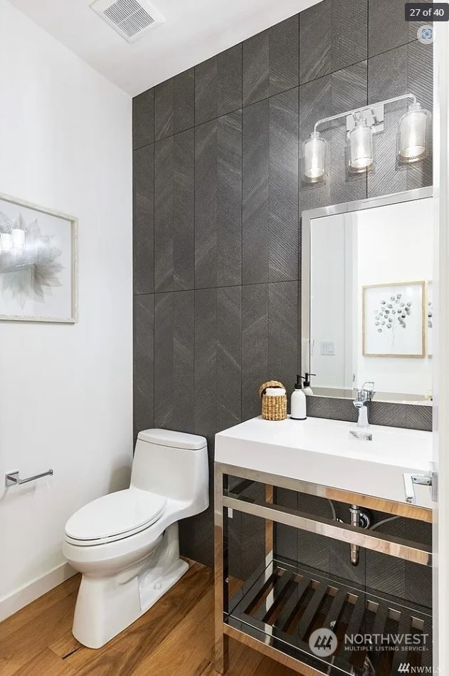 bathroom with wood-type flooring and toilet