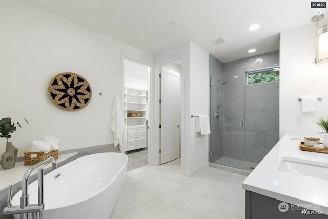 bathroom featuring vanity and separate shower and tub