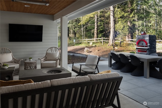 view of patio featuring an outdoor living space with a fire pit