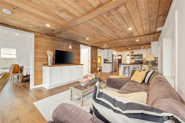 living room featuring wooden ceiling, wooden walls, light wood-type flooring, and beam ceiling