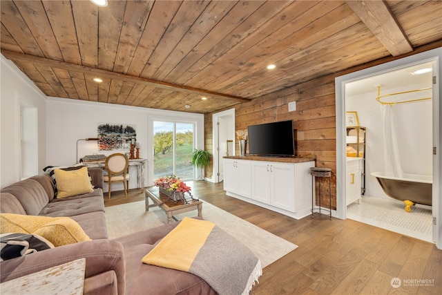 living room with light wood-type flooring, wood ceiling, wooden walls, and beam ceiling