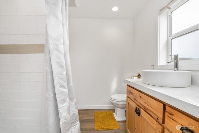 bathroom with toilet, a shower with curtain, vanity, and wood-type flooring