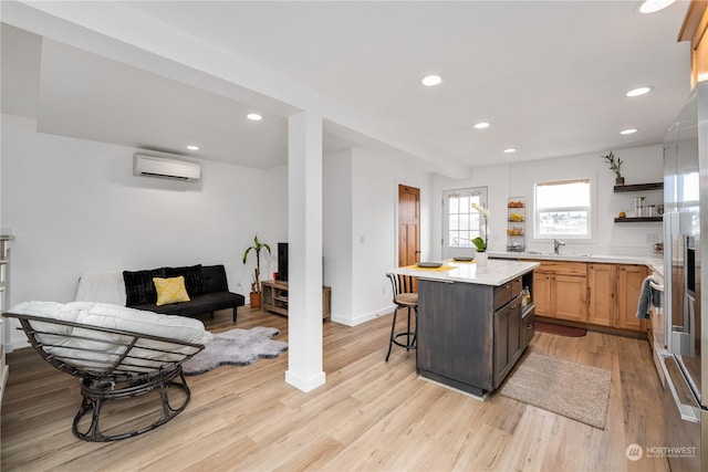 384 Washington St, Manson, WA 98831 - kitchen featuring a wall mounted air conditioner, open shelves, light countertops, light wood finished floors, and a kitchen breakfast bar