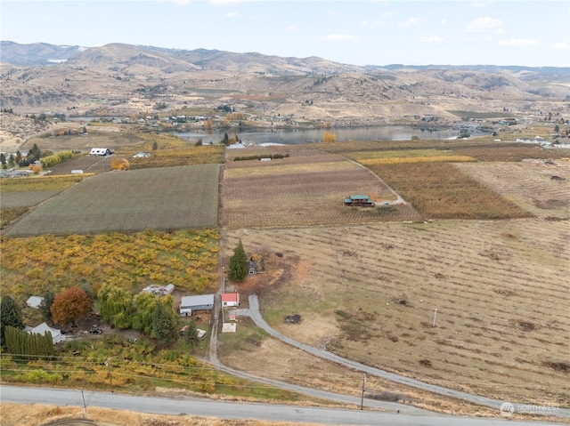 birds eye view of property with a water and mountain view and a rural view