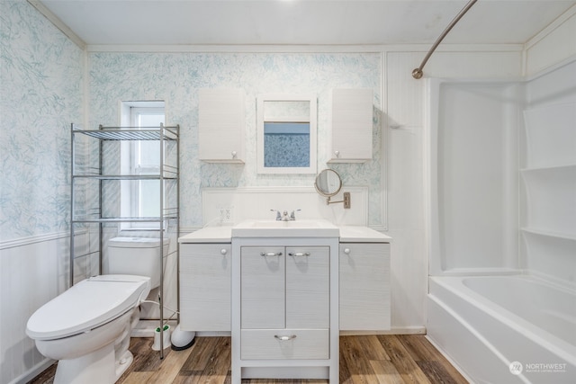 full bathroom with vanity, hardwood / wood-style floors, ornamental molding, and toilet