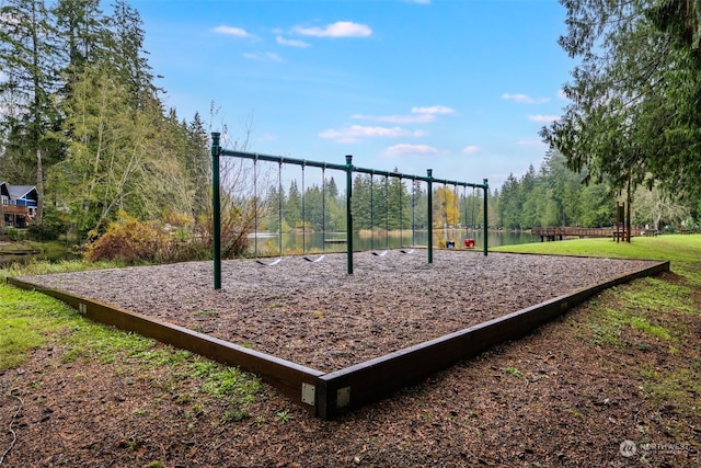 view of jungle gym featuring a water view