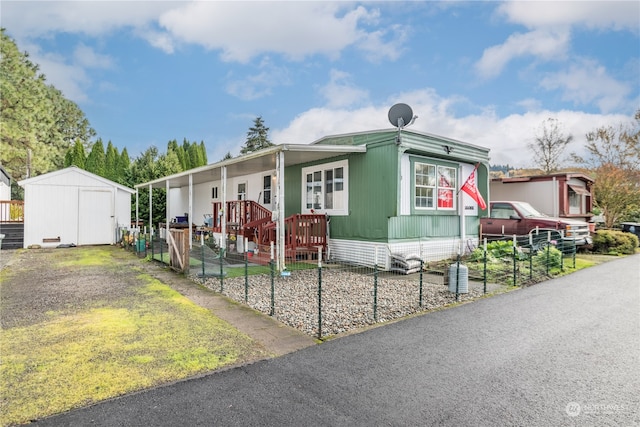 manufactured / mobile home with covered porch and a storage unit