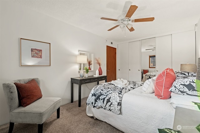 carpeted bedroom with ceiling fan, a closet, and a textured ceiling