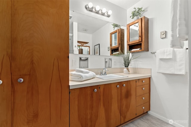 bathroom featuring hardwood / wood-style floors and vanity