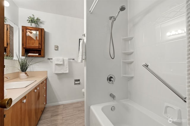 full bathroom featuring vanity, toilet, and tiled shower / bath