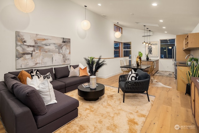 living room featuring light hardwood / wood-style floors and lofted ceiling