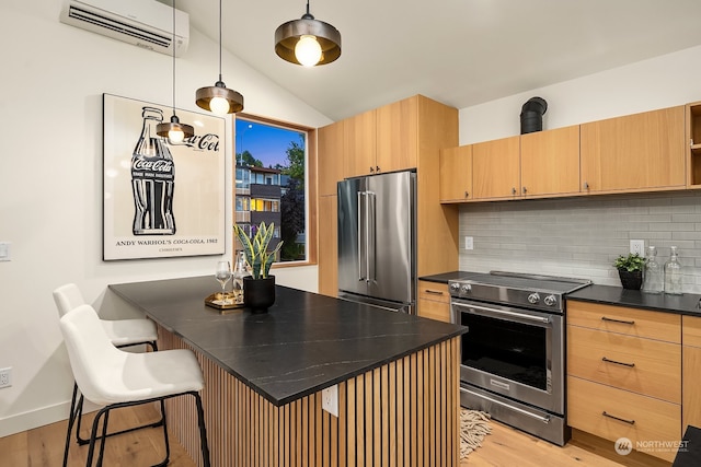 kitchen featuring hanging light fixtures, tasteful backsplash, an AC wall unit, a kitchen bar, and appliances with stainless steel finishes