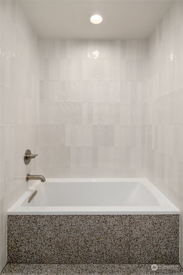 bathroom with tiled bath