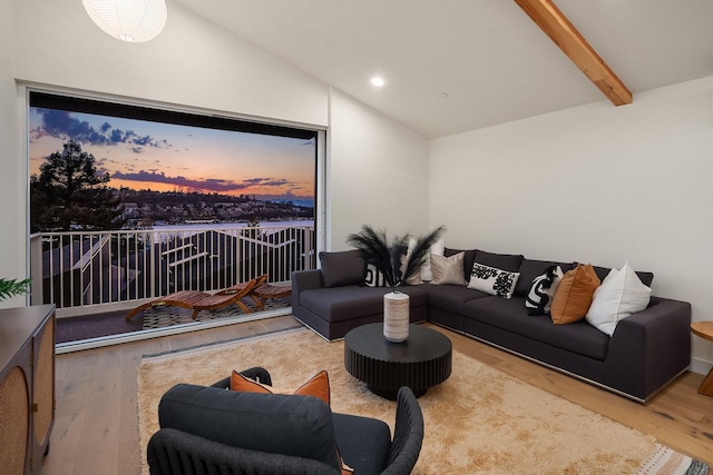 living room with lofted ceiling with beams and hardwood / wood-style floors