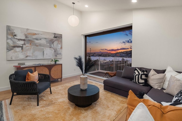 living room with lofted ceiling and light wood-type flooring