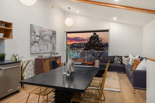 dining area featuring lofted ceiling and light wood-type flooring