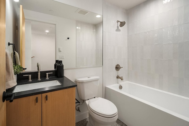 full bathroom with vanity, toilet, and tiled shower / bath combo