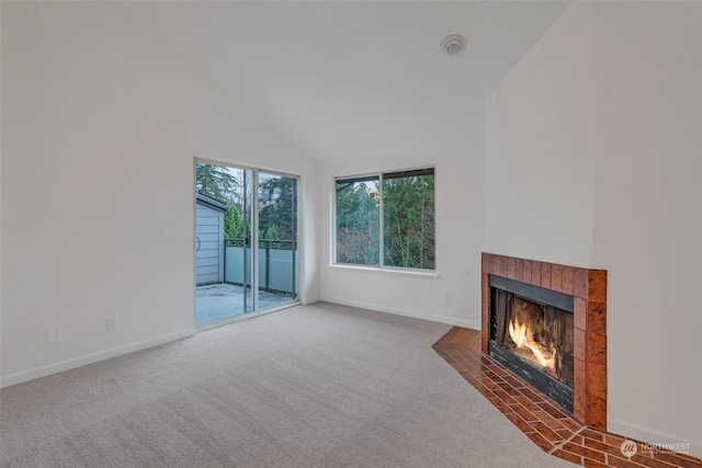 unfurnished living room featuring high vaulted ceiling, a tiled fireplace, and dark colored carpet