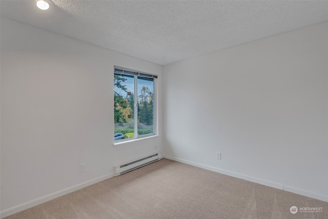 empty room with baseboard heating, carpet flooring, and a textured ceiling