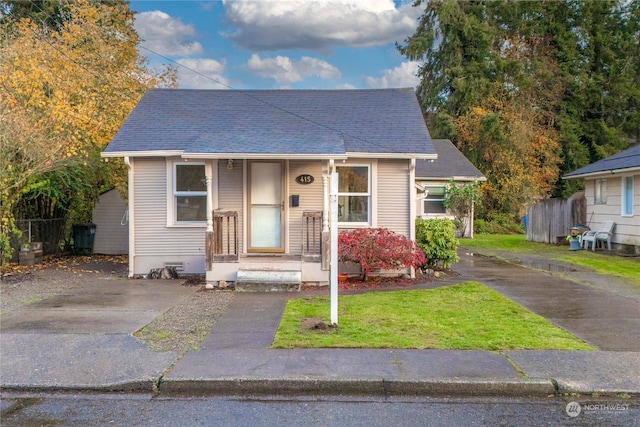 bungalow-style home featuring a front yard