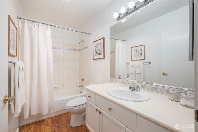 full bathroom with hardwood / wood-style floors, vanity, toilet, and shower / tub combo