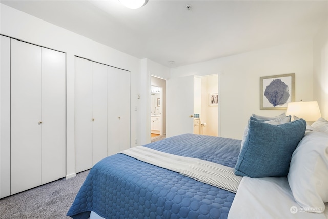 carpeted bedroom featuring two closets