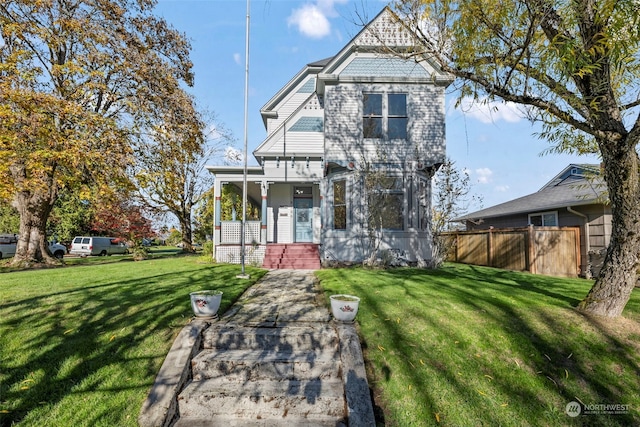 view of front of house with a front yard and covered porch