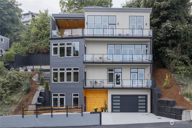 contemporary home featuring a balcony and a garage