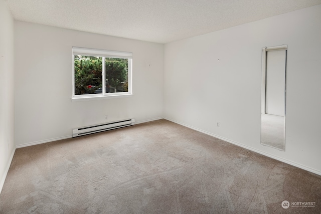 spare room featuring carpet floors, a baseboard radiator, and a textured ceiling